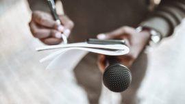 African Male Journalist Preparing Questions For Press Conference